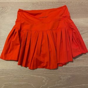 Gold Hinge ruffle skirt in XS in a reddish-orange color